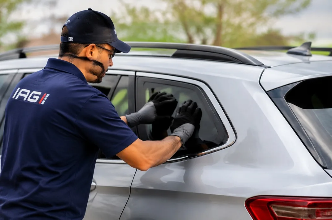 Technician replacing a quarter glass panel on an SUV in San Jose